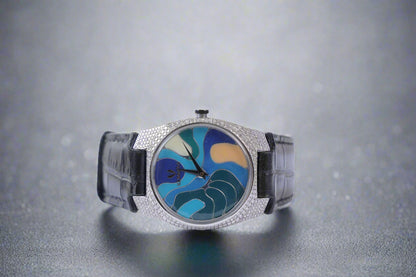 Luxury watch with a colorful face and black strap on a white background